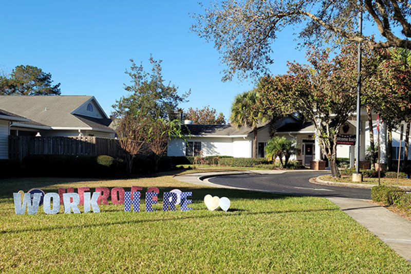 Front lawn with heros work here sign at Superior Residences of Cala Hills
