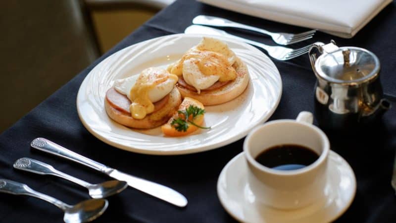 Eggs Benedict served with black coffee