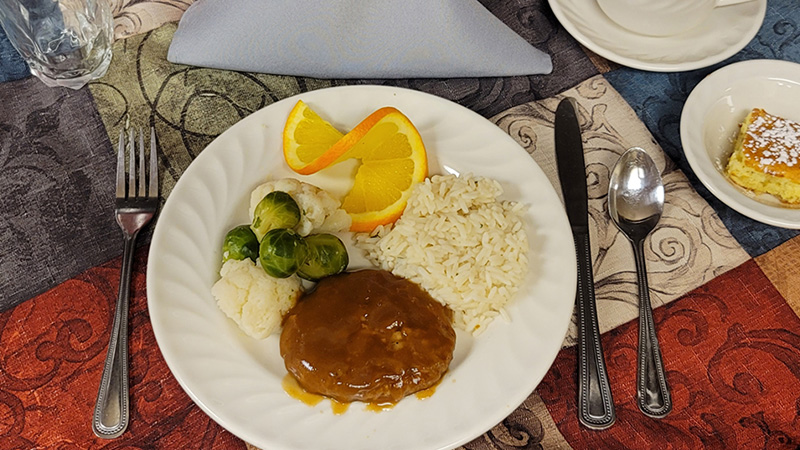 Salisbury steak dinner with rice, cauliflower and brussel sprouts